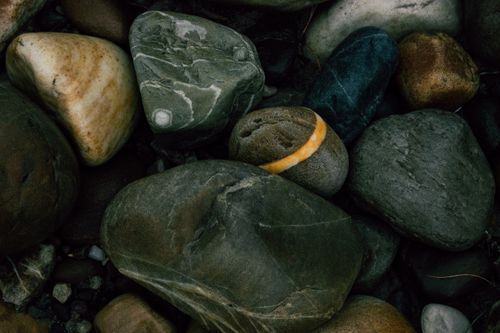 Free Top view of rough pebbles placed side by side on shore of sea Stock Photo