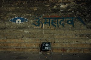 Shabby stone wall with eye ornament and Hindi inscription
