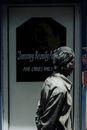 Side view of unrecognizable female walking past doorway of hairdressing salon and looking away