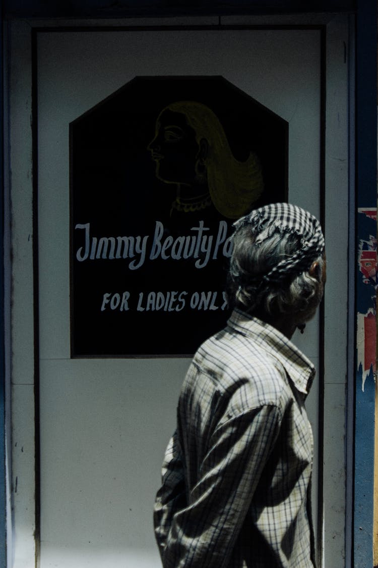 Woman Walking Near Entrance Of Beauty Salon