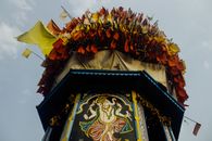 Low angle of colorful flags fluttering on wind on top of tower for traditional oriental celebration