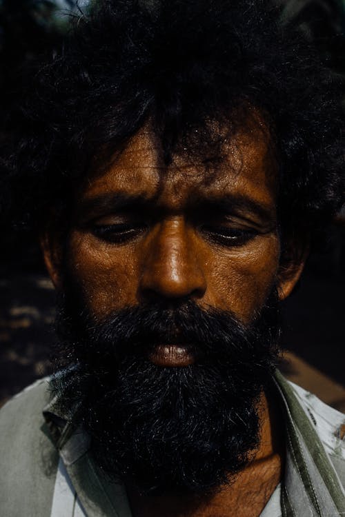 Upset ethnic bearded man with messy hair