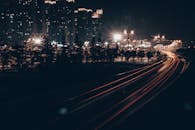 City Street Lights and Trees Along a Road at Night