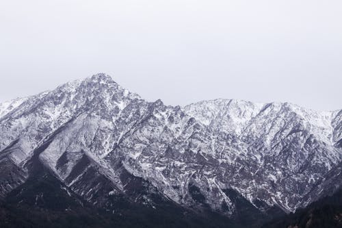 Free Aerial Photography of Rock Mountain Covered With Snow Stock Photo