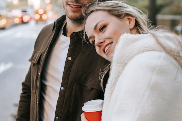 Couple On Date In Street With Coffee Cup