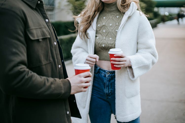 Anonymous Stylish Couple Drinking Takeaway Coffee On Street