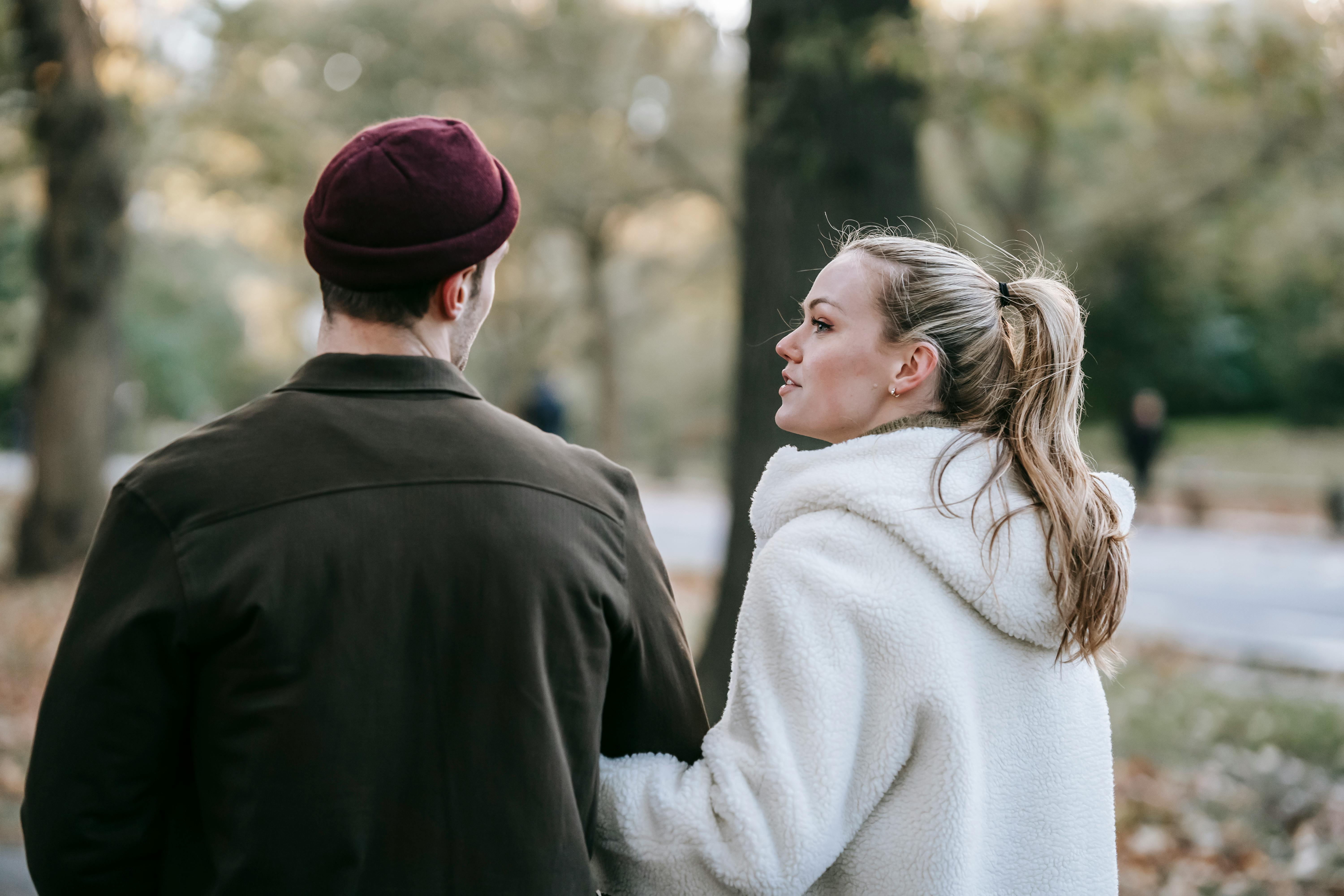 young romantic couple walking and communicating in autumn park