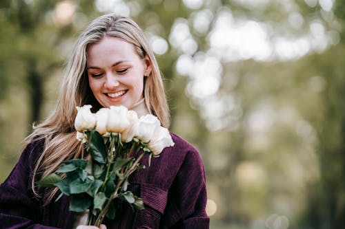 Smiling woman with bouquet of roses