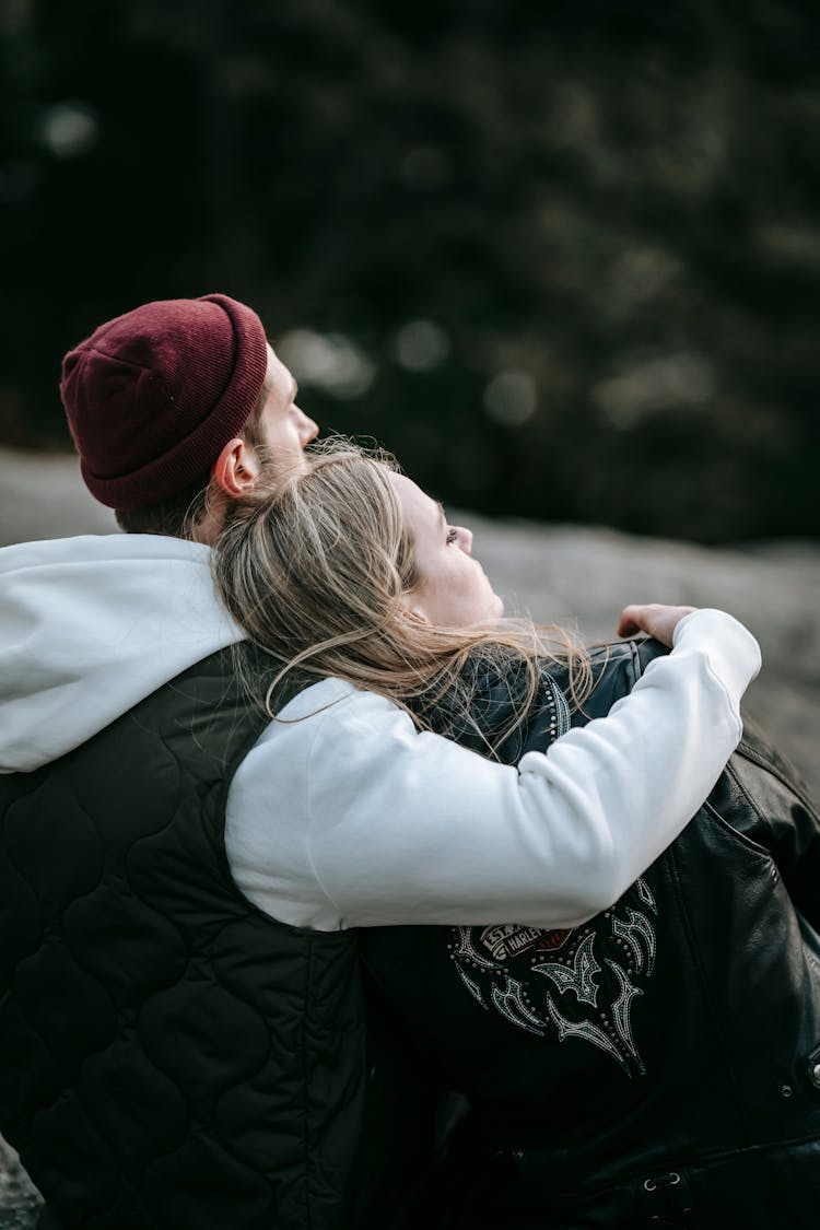 Contemplative Couple Embracing In Park In Daylight