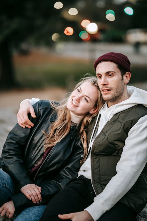 Contemplative couple embracing in city park in fall