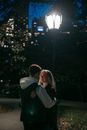 Romantic couple hugging in park at night