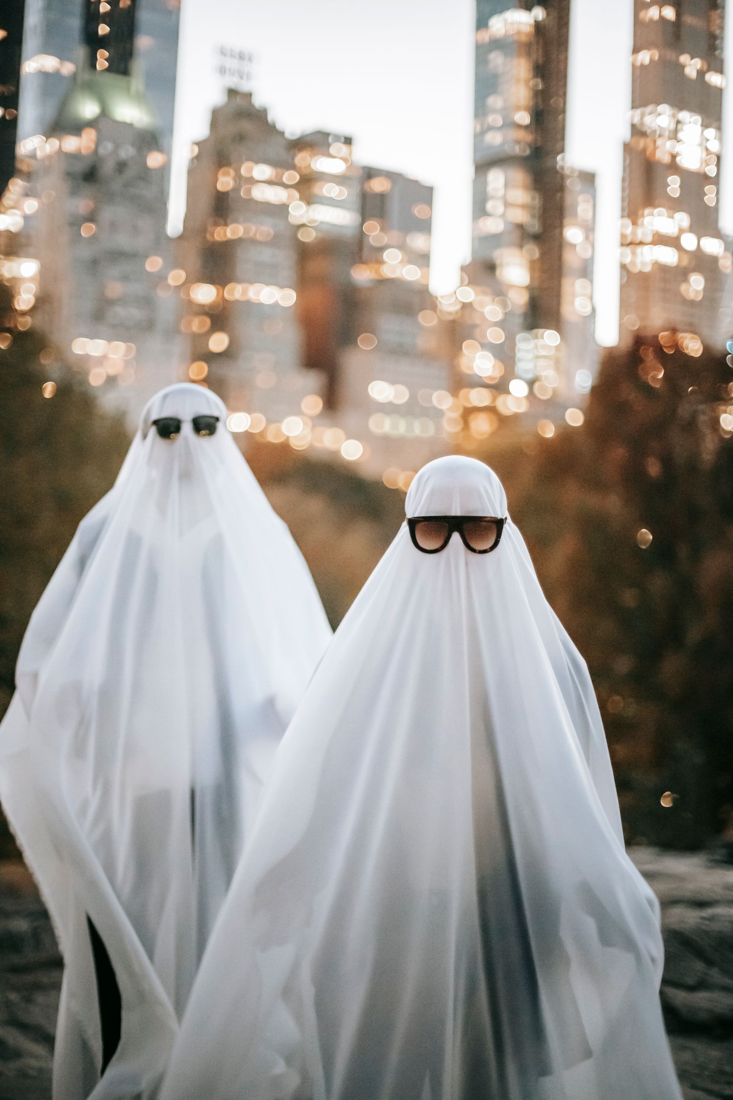 Unrecognizable Couple In Ghost Costumes In City Free Stock Photo Unrecognizable Couple In Ghost Costumes In City Free Stock Photo
