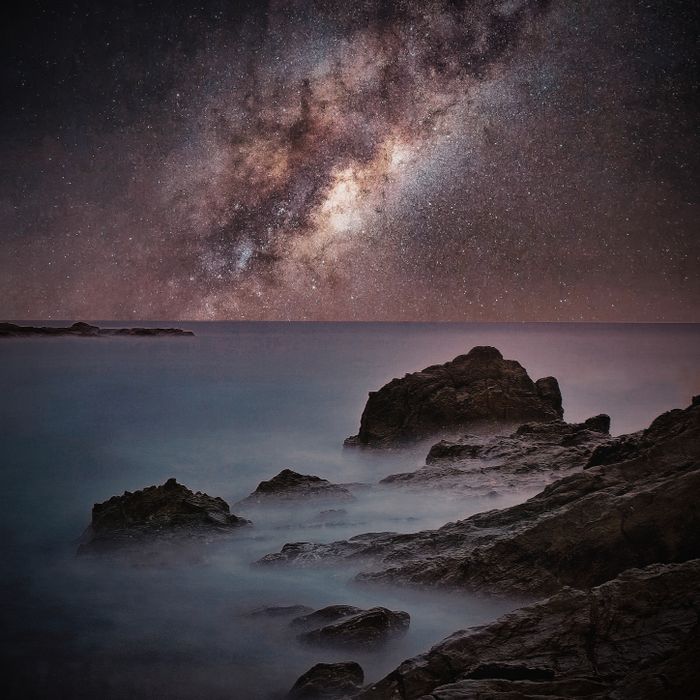 Starry night sky above a rocky coastline — photo by Hakan Tahmaz on Pexels