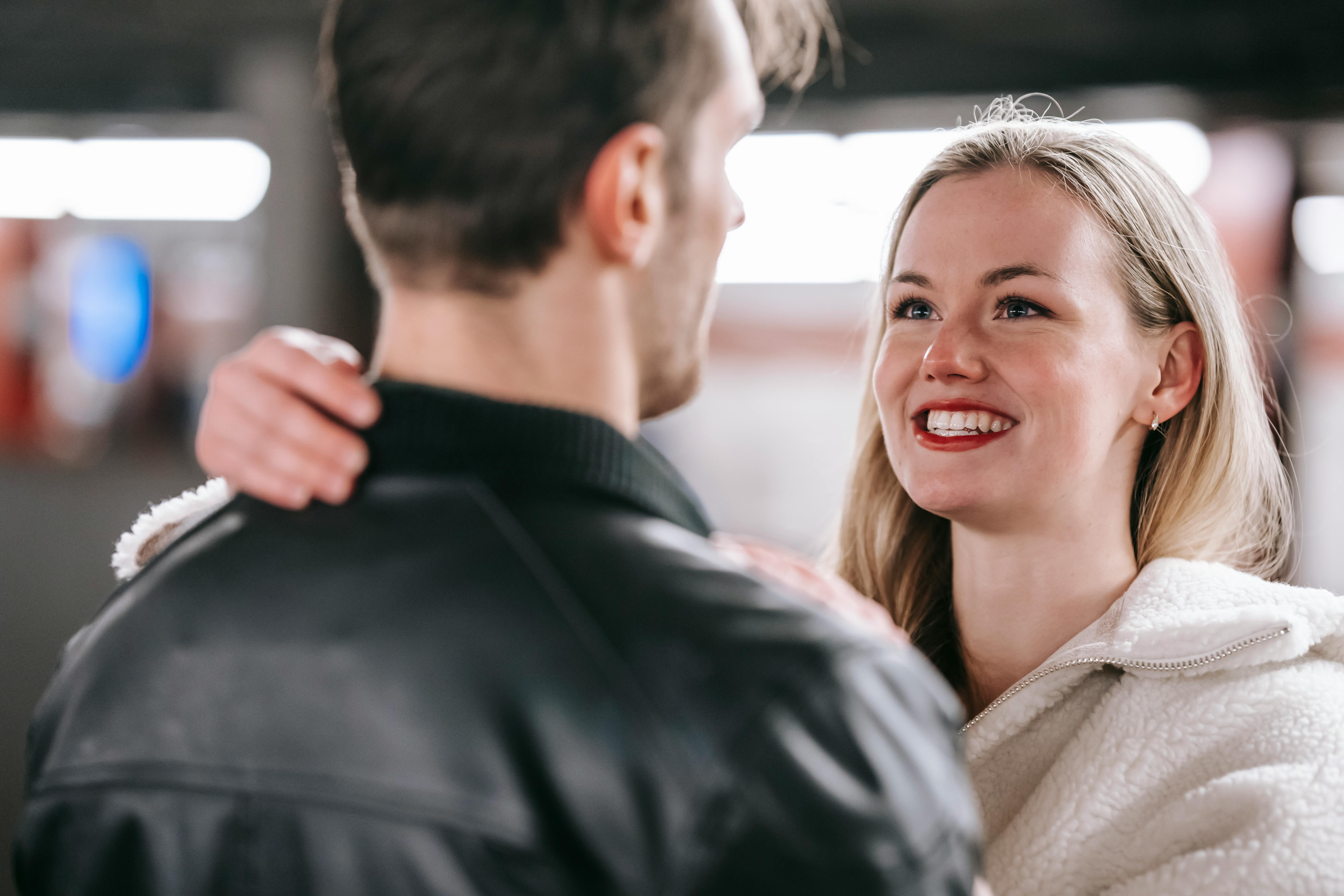 happy young couple embracing in metro