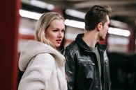 Couple standing in underground station together