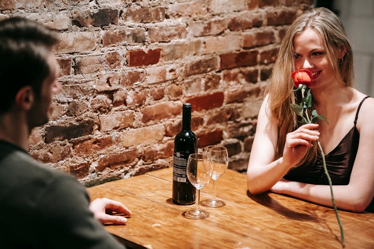 Couple Having Romantic Date In Bar With Wine