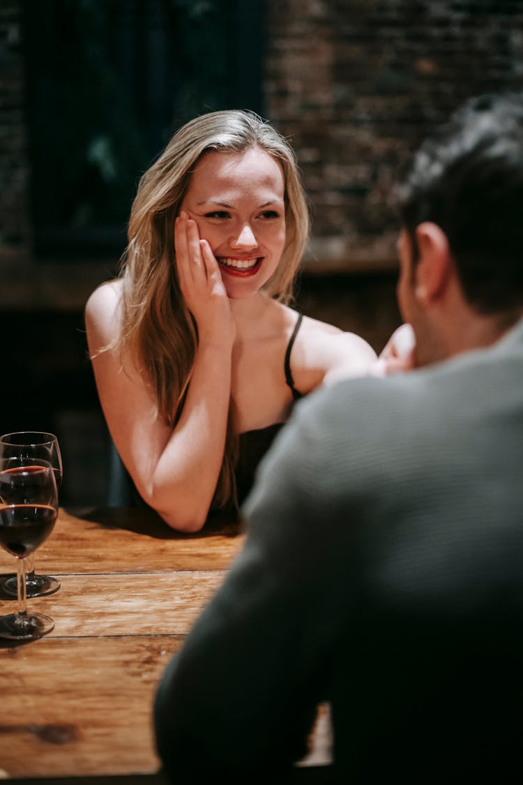 Couple Having Romantic Dinner In Cafeteria With Wine