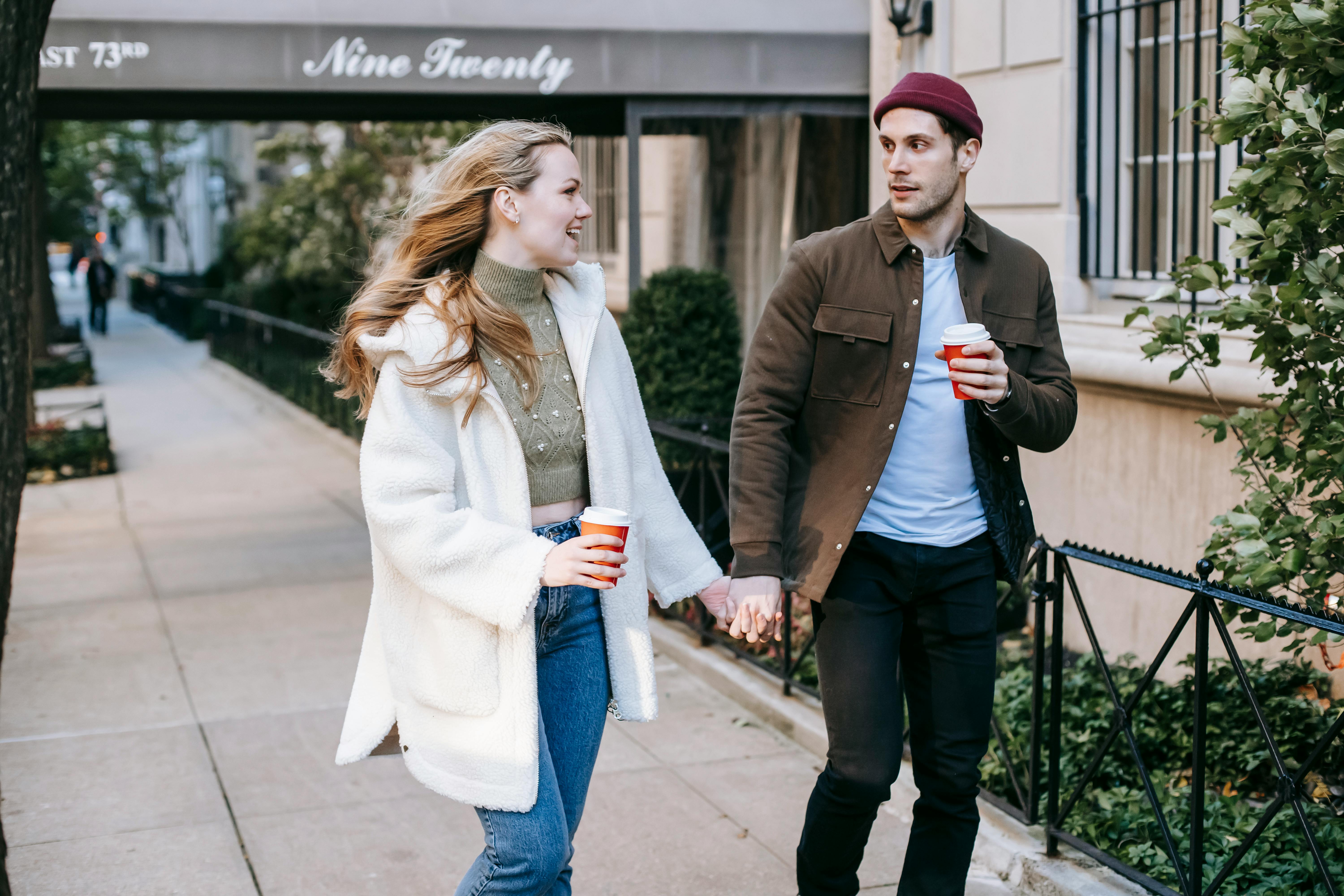 happy young couple walking on street