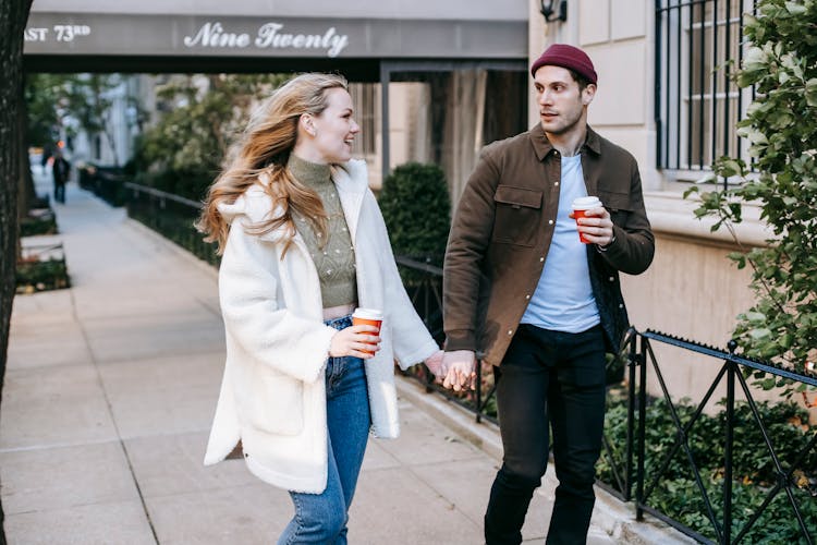 Happy Young Couple Walking On Street