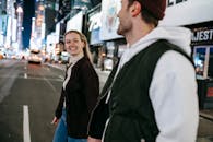 Positive couple walking on road