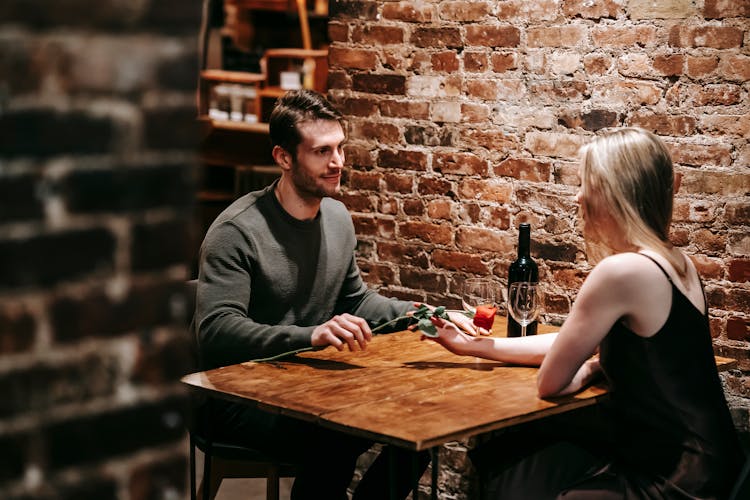 Romantic Couple Having Date In Cafe With Wine