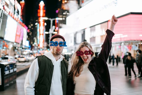 Delighted couple in stylish glasses on street