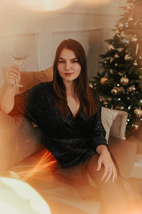 Free Woman Sitting On White Couch With A Cocktail Drink Stock Photo