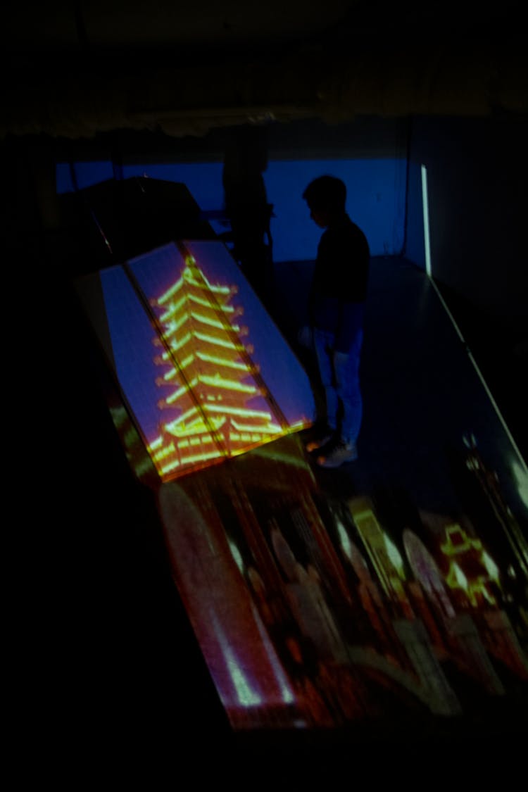 Man Near Picture Of Chinese Pagoda