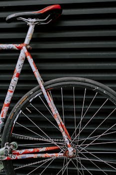 Detailed close-up of a colorful bicycle against a striped background.