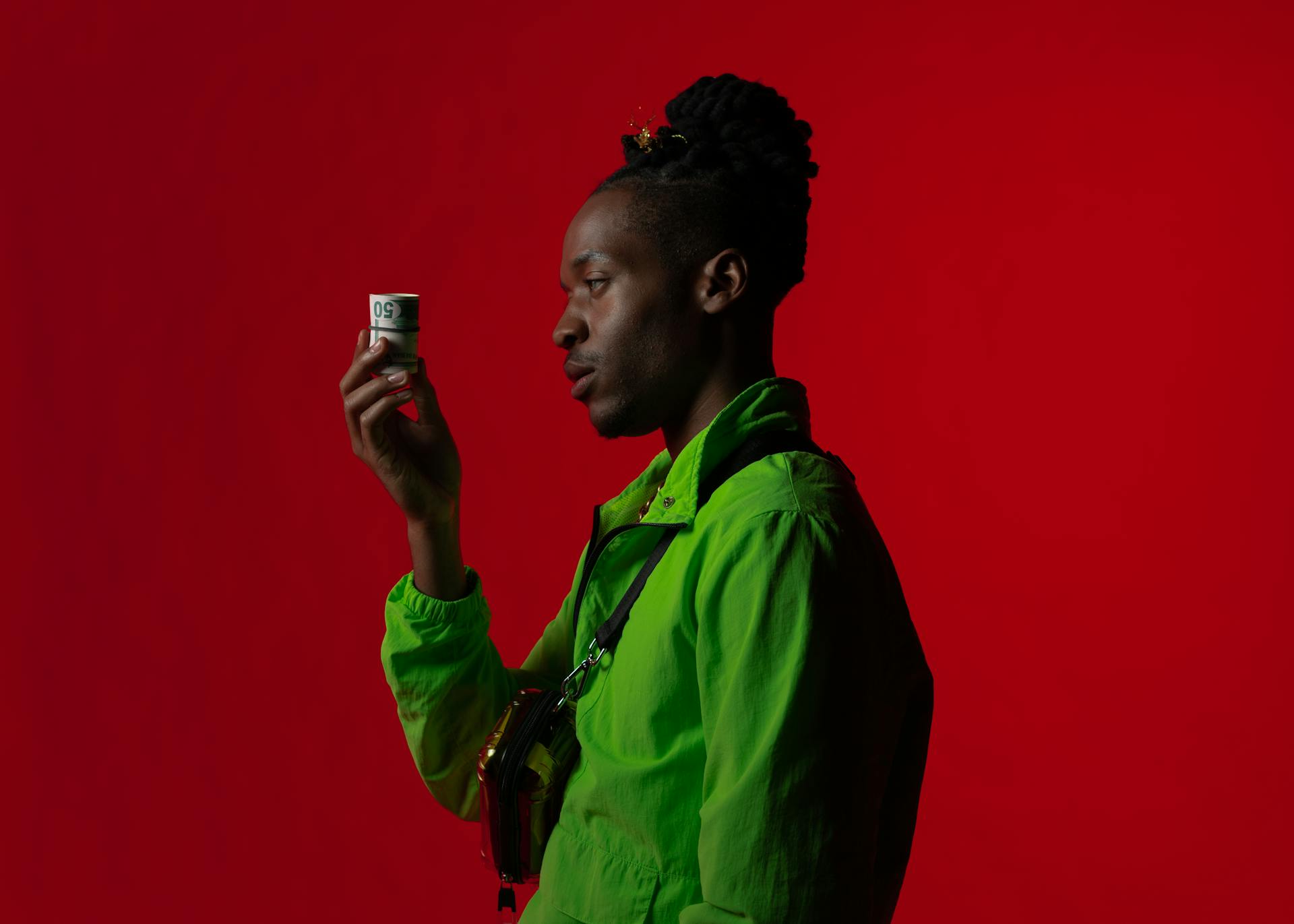 Man in Green Button Up Shirt Holding Rolled Banknotes