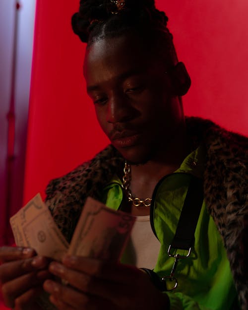 Man with Dreadlocks Counting Money