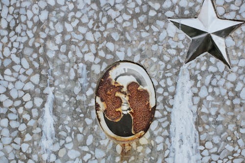 Rusty memorial picture on gravestone at cemetery