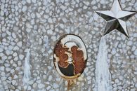 Rusty memorial picture on gravestone at cemetery