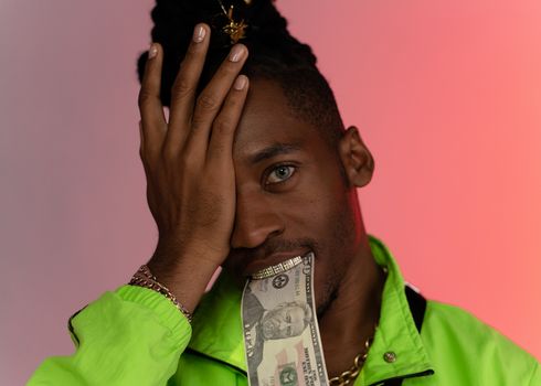 Man in Green Jacket Covering His Eye