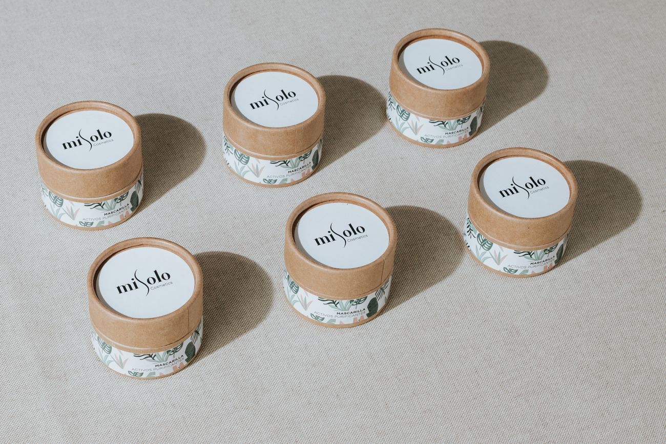 Beauty containers displayed in simple paper-based packaging