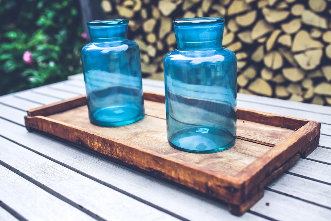 Two blue jars on the wooden tray