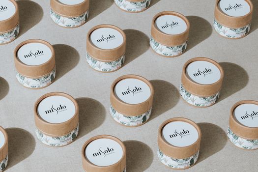 Patterned display of eco-friendly cosmetic jars highlighting sustainable beauty packaging.