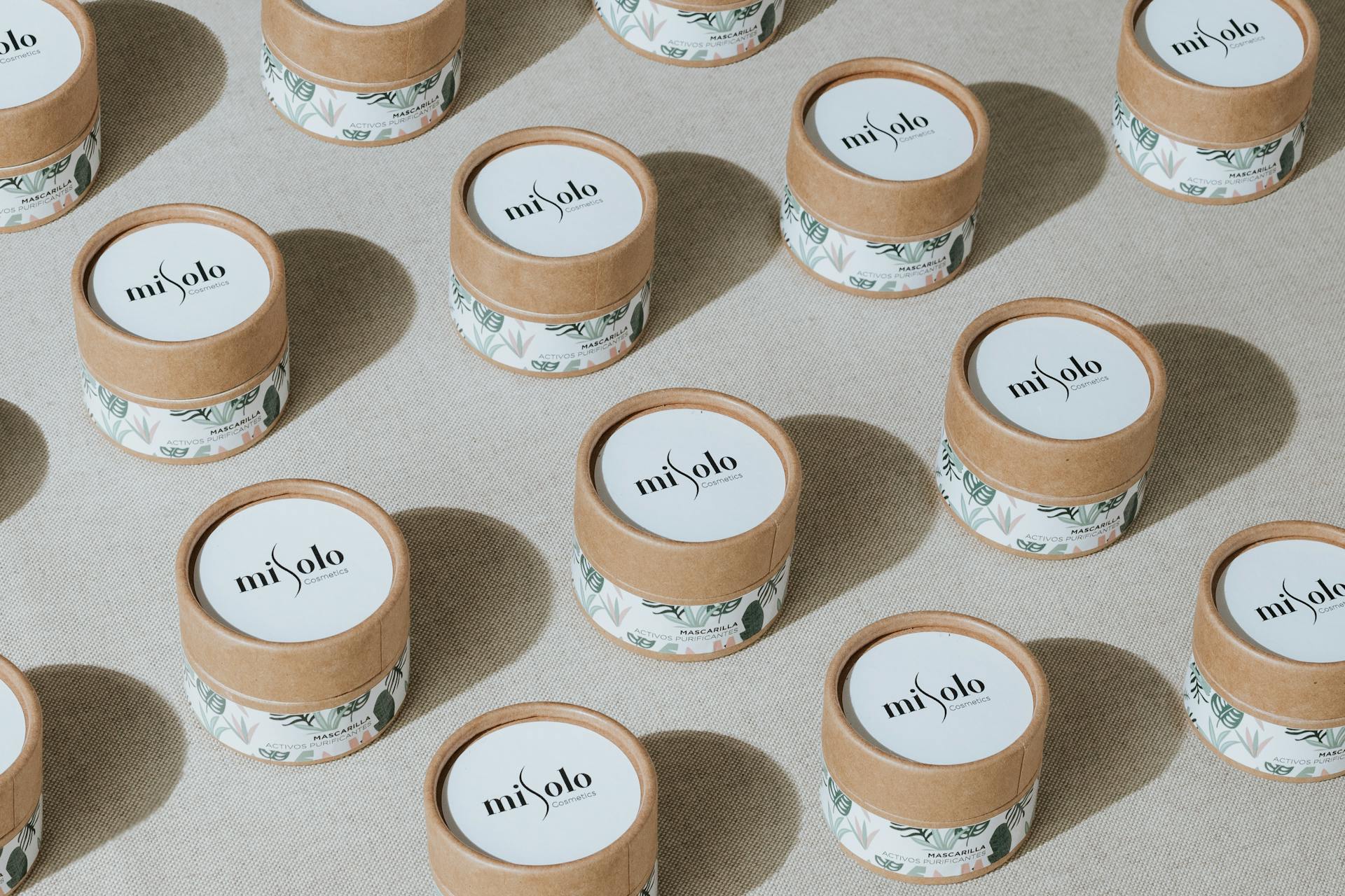 Patterned display of eco-friendly cosmetic jars highlighting sustainable beauty packaging.