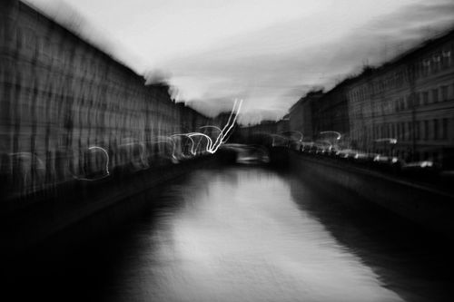 Free Black and white of wide river flowing in city near streets with cars and houses Stock Photo