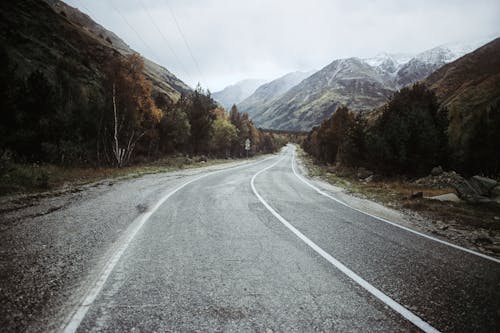 Asphalt road running among mountains