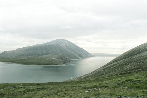 Wide river flowing near massive mounts