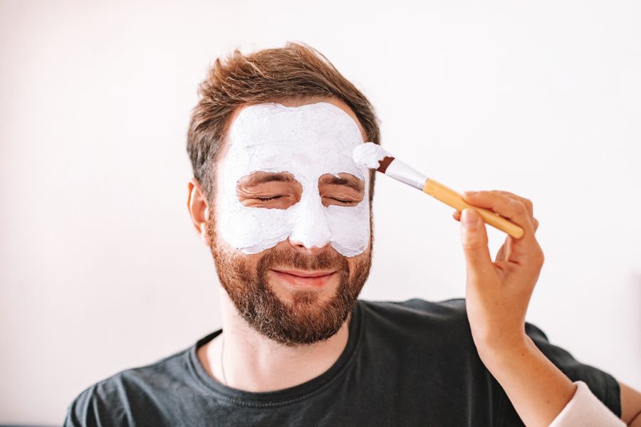 Beautician completing a relaxing face mask treatment