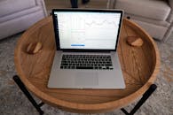 Macbook Pro on Brown Wooden Round Table