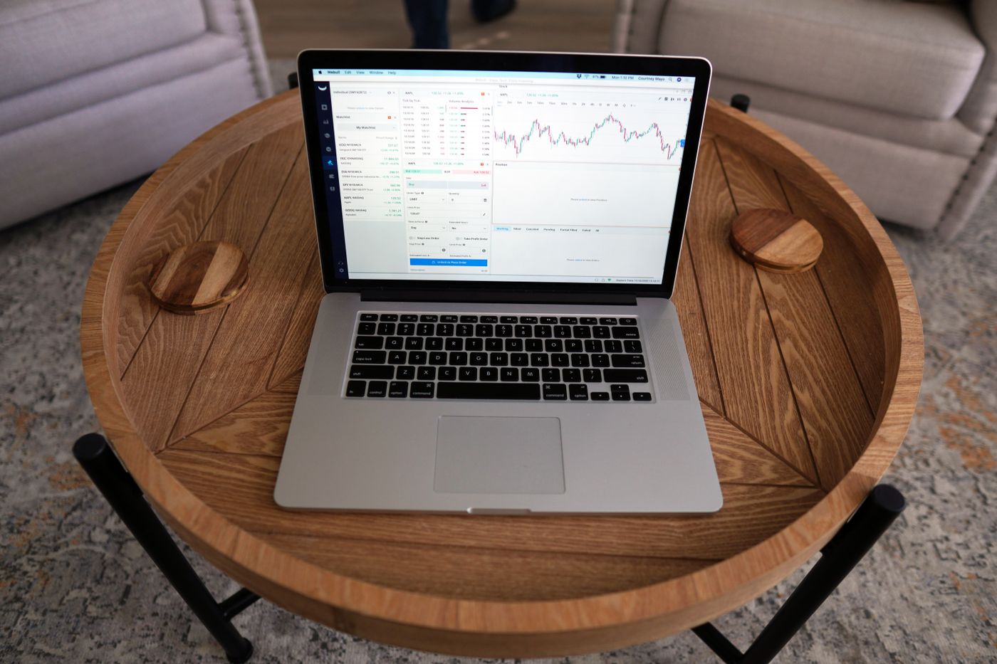 Laptop displaying trading charts for paper testing an options strategy
