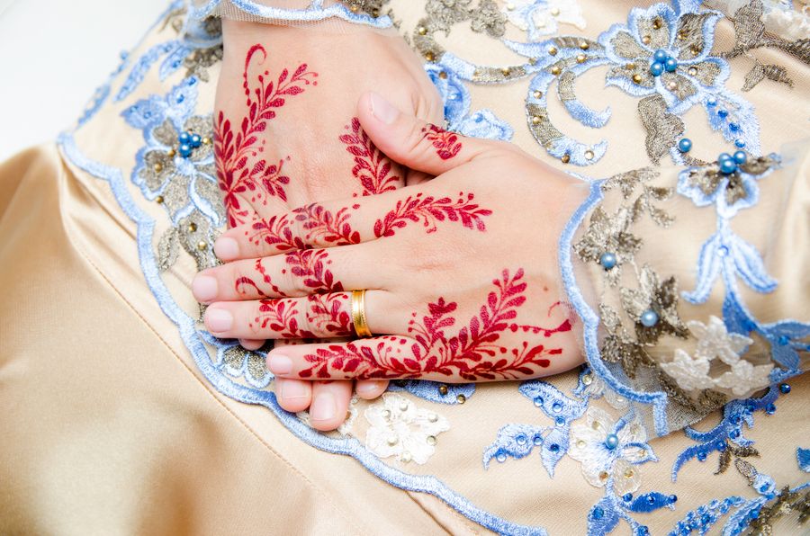 Bridal henna on hands with a ring