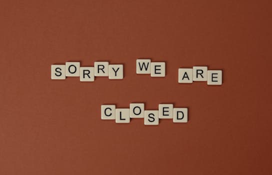 Photo by Tima Miroshnichenko Scrabble tiles on a brown surface forming the phrase 'Sorry We Are Closed' with copy space.