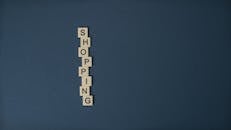 Arranged Scrabble Tiles on Blue Surface