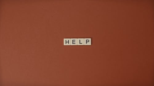 Free Close-Up Shot of Text on a Brown Surface Stock Photo