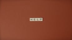 Close-Up Shot of Text on a Brown Surface