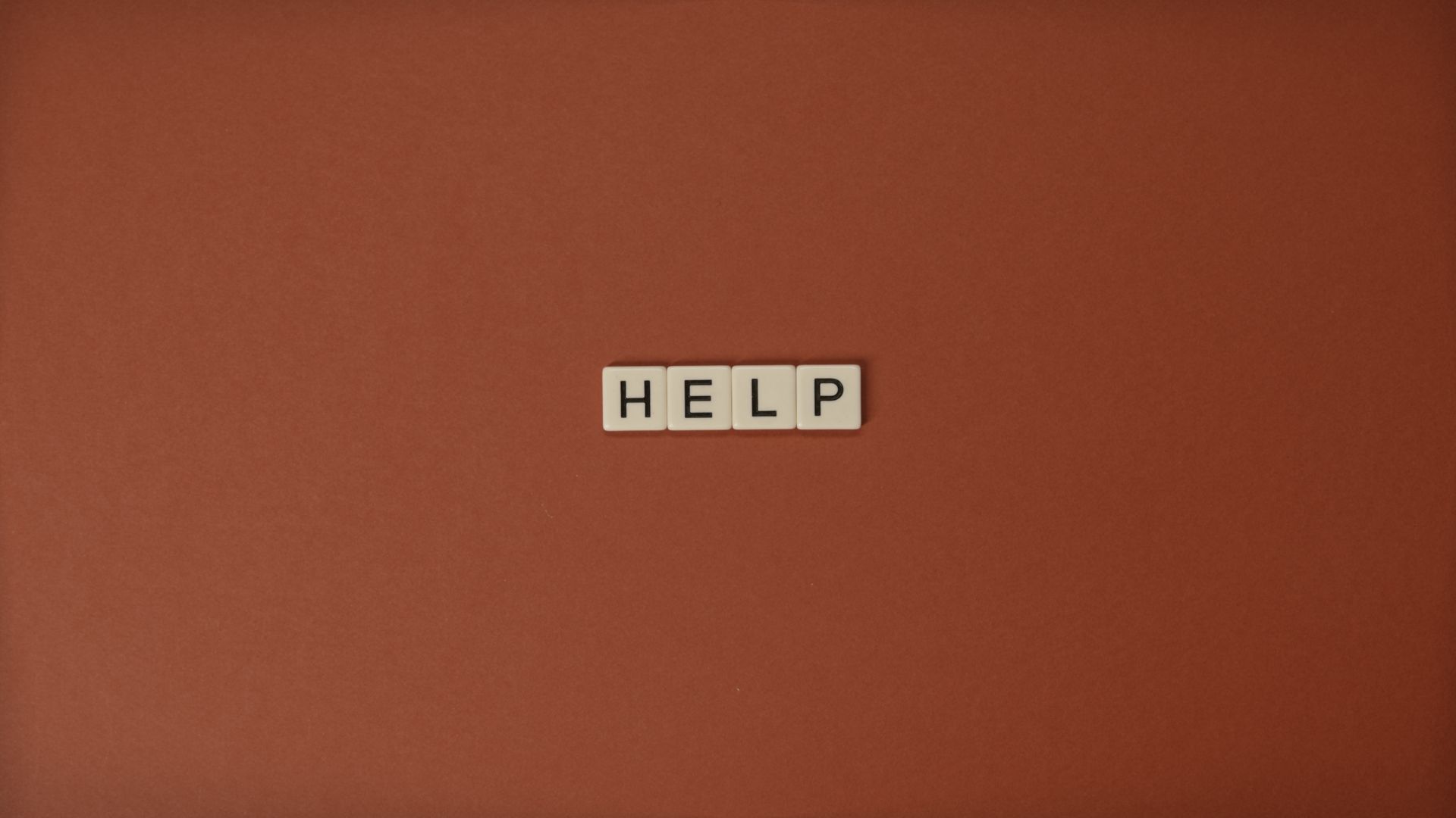 Close-Up Shot of Text on a Brown Surface